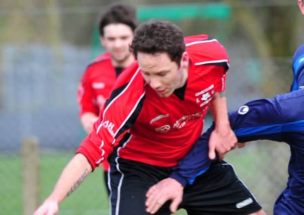 Cookstown Olympic and Cookstown RBL battle for the ball in midfield during Saturady's local derby clash at Beechway.INMM0415-390