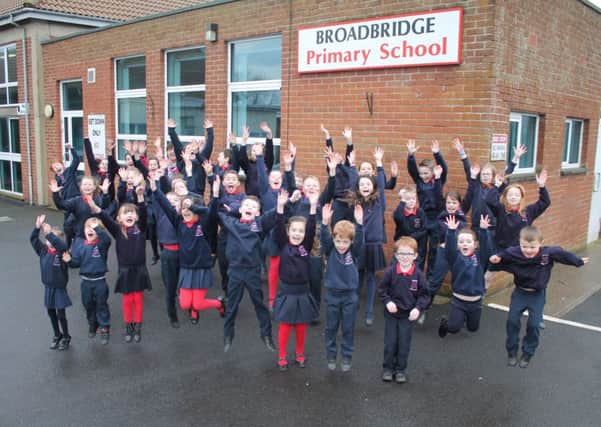 Pupils from Broadbridge Primary School celebrate the good news that the school is to receive substantial funding.
