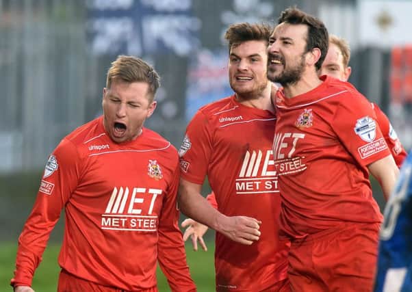Delight for, from left, Mark McAllister, Philip Lowry and Michael Gault following Portadown's third goal against Coleraine.