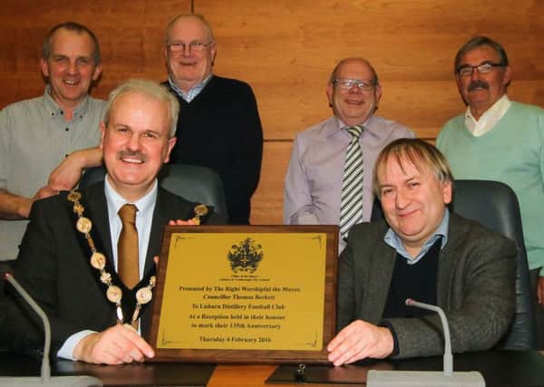 The Mayor of Lisburn & Castlereagh City Council, Councillor Thomas Beckett presents a plaque to Lisburn Distillery secretary and director Colin Hopkins at a reception in the Island Centre last Thursday. Also looking on are (l-r) Ged Irwin, Terry Thompson, Jim Mulholland and Bobby Radcliffe. Picture - David Hunter.