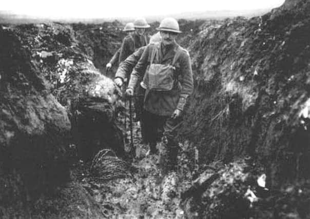 Trench collapse: The C.O. of the 12th Royal Irish Rifles and other officers make their way up a communication trench.