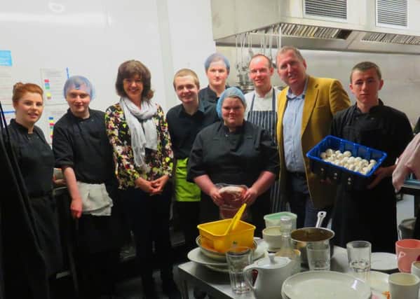 Fiona Rowan (third left) and Councillor Doug Beattie (third right) with chefs and trainees in the kitchen of CafÃ© 180.