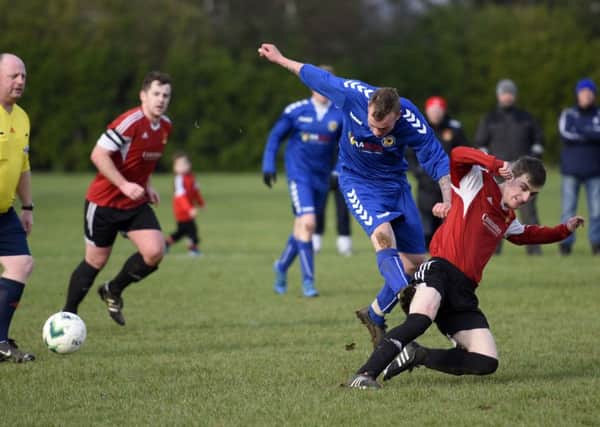 Foyle Wanderers player Conor Kelpie slides in to tackle Lincoln Courts midfielder Gary King. INLS0716-108KM