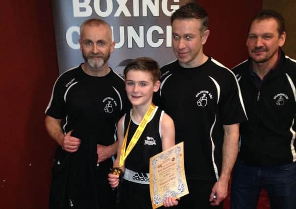 Ben Cooke pictured along with the Eglinton Boxing Club trainers.