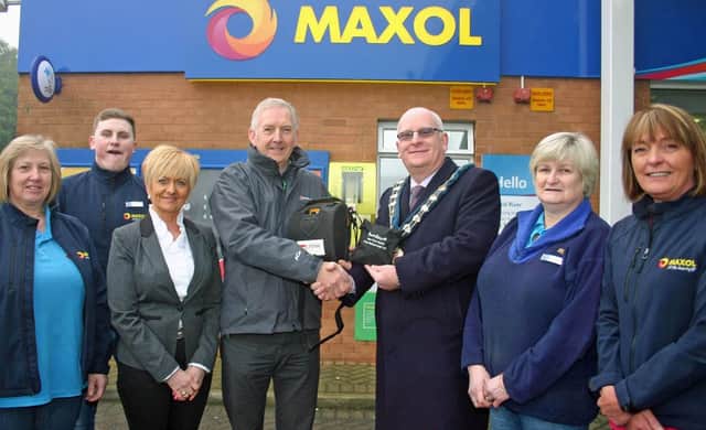 Mid & East Antrim Mayor Billy Ashe congratulates Cllr Billy Ashe, congratulates (from left) Jenny Wade, Frank McDowell, proprietors Isobel Warwick and Chris Warwick, Pauline McClure and Jacqui Henry on their adventurous fundraising efforts which that allowed the purchase of a lifesaving cardiac defibrillator at the Braid River Service Station. (Submitted Picture).