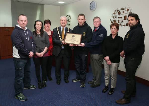The Mayor, Councillor Thomas Beckett and Alderman Paul Porter, Chairman of the Leisure & Community Development Committee present a brass plaque to the Committee and Volunteers of Hazama Judo Club Maghaberry.