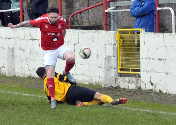 Ciaran Murray escapes this tackle during Larne's 2-1 win over Harland and Wolff Welders in the Intermediate Cup. INLT 07-216-AM