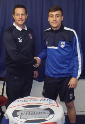 Moneyslane manager David Johnstone welcomes new signing Michael Ferguson to the club.