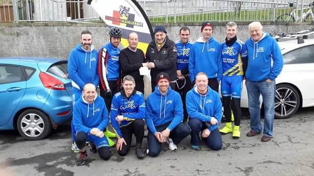 Pictured after the successful charity coastal run last Saturday at katesbridge club chairman Billy Maxwell hands over a cheque to Danny Blondell for the Belgium project as members of the West Down Wheelers look on.
