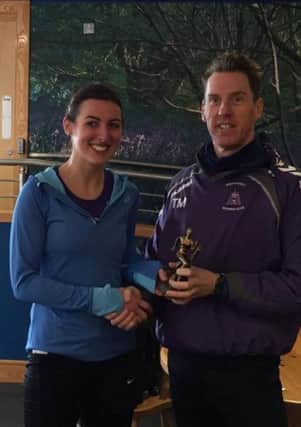 Ciara McSherry receiving her award from Thomas Moore for 1st Lady at the O'Cahans Trail Race