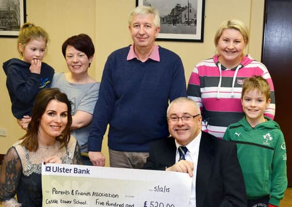 Sarah, chairperson of Parents and Friends Association Castletower School receives a Â£520 cheque from Roy Gilmore, Chairman Masonic Seven Towers Charity Committee. Looking on were Mason Alan Mercer, Karen and Emily with Kerry and Oliver. INBT 09-801H