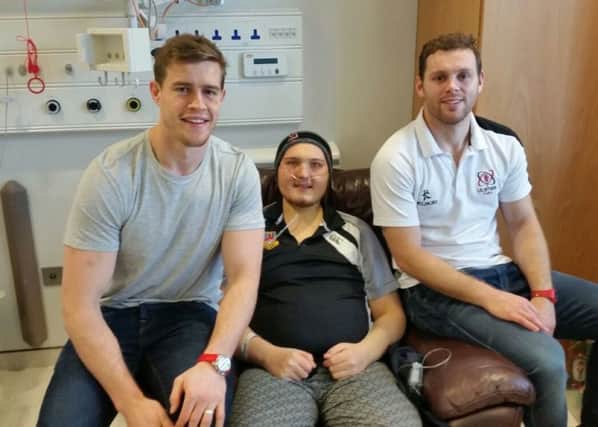 Kieran Bowes pictured with two of his Ulster rugby heroes, Andrew Trimble and Darren Cave, who visited him in hospital before Christmas.