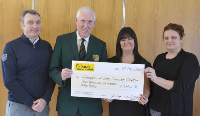John Boyd presents a cheque for Â£9,605 to Claire Hogarth from Friends of the Cancer Centre watched by Stephen Hamill and Jane McCambley.