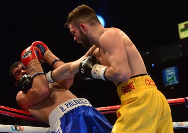 PACEMAKER BELFAST  28/02/2015
Boxing at the Odyssey Arena.
Conrad Cummings (yellow/blue shorts) and  Roberto Palenzuela (blue) during their Middleweight contest in Belfast.Pic Colm Lenaghan/Pacemaker