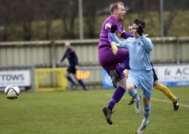 H&W Welders keeper Michael Dougherty rushes off his line to challenge Institute striker Gareth Brown. INLS0816-101KM