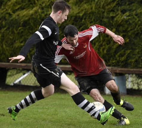 Foyle Wanderers forward Robbie Godfrey keeps Ardmore's Damien Campbell on his toes. INLS0816-114KM