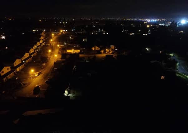 Stark contrast: an area with the old orange lights on the left and the new LED lights on the right.