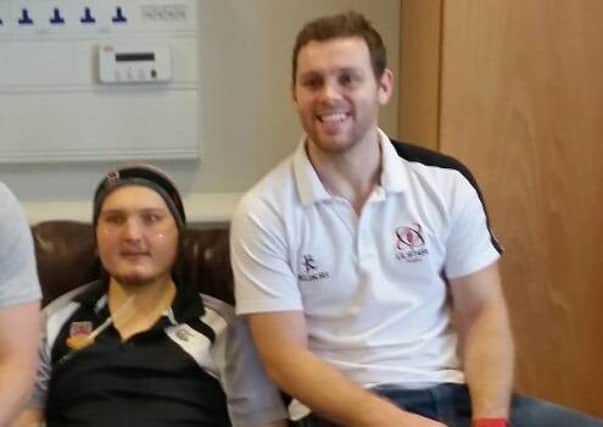 Kieran Bowes pictured with Ulster and Ireland rugby star Darren Cave before Christmas.