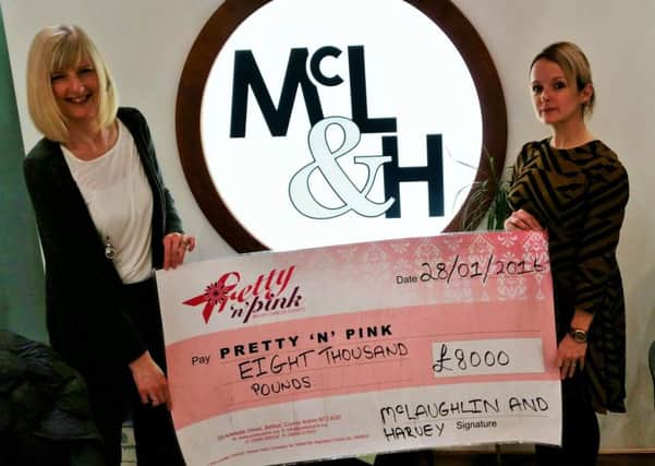 McLaughlin & Harvey employees Lynne McLean and Lois Hillen (right) handing over the cheque for Â£8,000. INNT 08-504CON