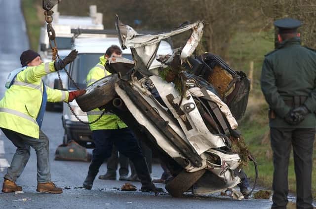 The wreckage of the Vauxhall Corsa is removed from the scene of the accident in February 2004