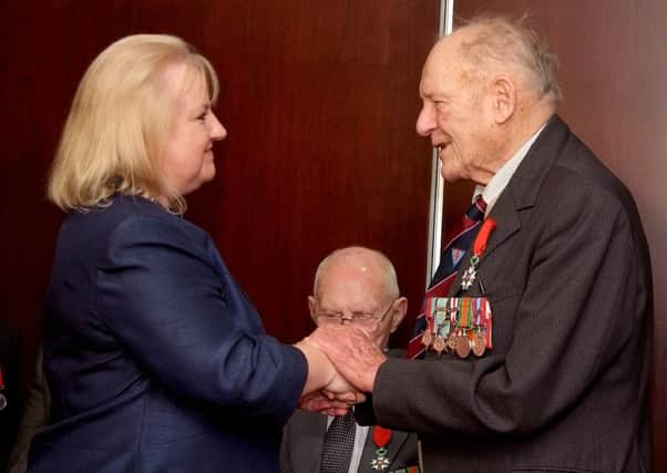 Regine McCullough presents the Legion D'honneur to Frank Ferguson from Ballycarry. INLT-08-700-con
