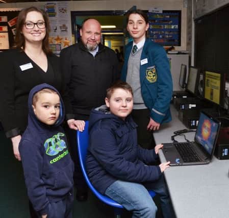 Slemish College ICT teacher Mrs Scullion with pupil Duncan and some of the visitors to the open night who played computer games. INBT 06-815H