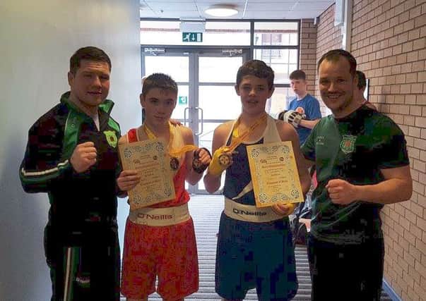 Tyler McMullan and Christie Convery cekebrate their Ulster title succeses with All Saints ABC coaches TJ and Dermot Hamill.