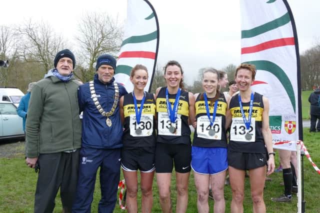Dromore Athletics Club coach Michael McGreevy (left) with Laura Bickerstaff, Rebecca Henderson, Rebekah Nixon and Diane Wilson, who earned the club's first ever NI & Ulster XC Championships medal by bringing home silver. Also included is  Gary Keenan (President, Athletics NI).