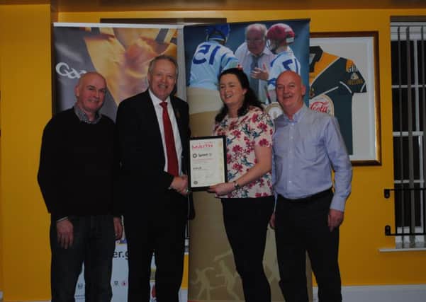 Ciara Connolly, Secretary Tullylish GAC, receives the Club Maith Gold Certificate from Ulster Council President Martin McAviney.  Also included from Tullylish are Club Maith sub-committee members John McDermott and Niall O'Dowd.