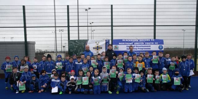 8 to 11 year olds who took part in the Northend Youth - Blackburn Rovers Community Trust Partnership Football Camp at Ballymena Showgrounds last week. Included are Blackburn Rovers coaches Nick, Fergus and Jonathan. INBT 08-170CS