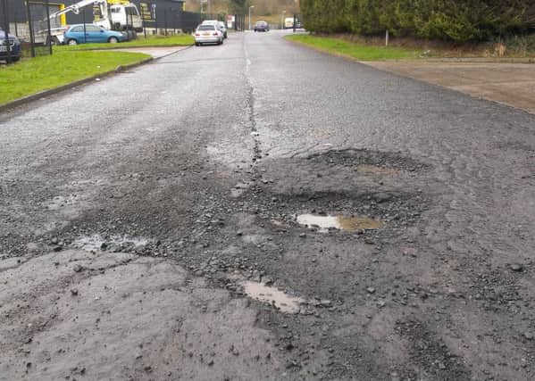 The potholes on the road outside Larne MOT centre. INLT-08-705-con