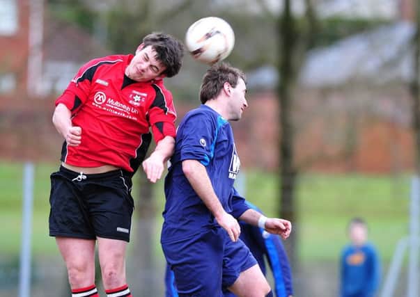 Cookstown RBL's James McPartland is beaten to the ball by a Cookstown Olympic defender during Saturday's derby clash played at Beechway.INMM0816-344