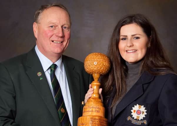 Outgoing Tandragee Golf Club captain Hamilton Loney making a special presentation to Olivia Mehaffey.