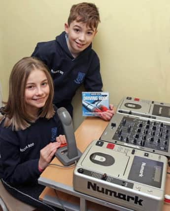 PLAY TIME....Pupils Rebecca Wallace and Stuart Finney, just two of 'djs' who provide music, requests and information from the school radio station.INBM8-16 001SC.