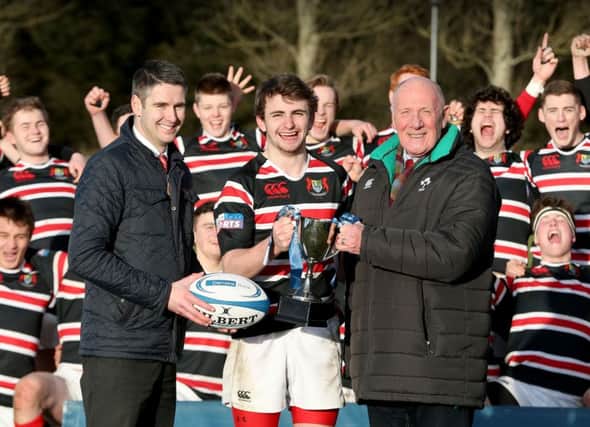 Banbridge Academy's Michael McGaffin collects the Schools' Trophy from Andy Donaldson, Danske Bank Mallusk Branch manager and Stephen Hilditch. Pics: Matt Mackey / Presseye