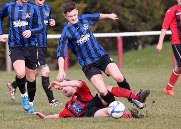 Drummond United's Liam O'Kane tackles BBOB player Liam Doherty on Saturday. INLV0916-396KDR