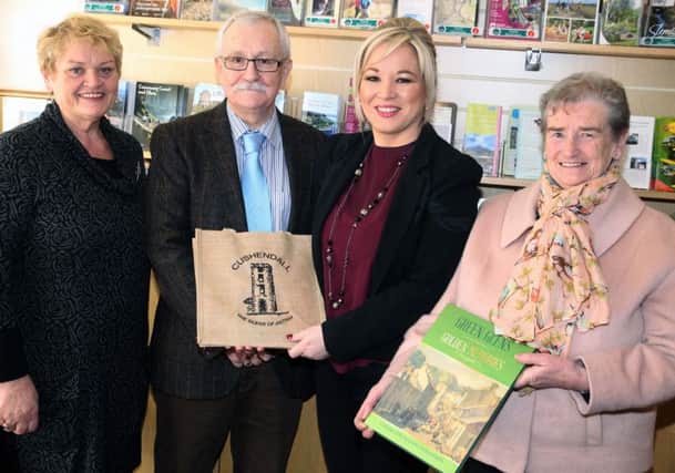Bernie Delargy and Eilleen McAuley, from Cushedall tourist office, present Michelle O'Neill with gifts as Oliver McMullan MLA Looks on