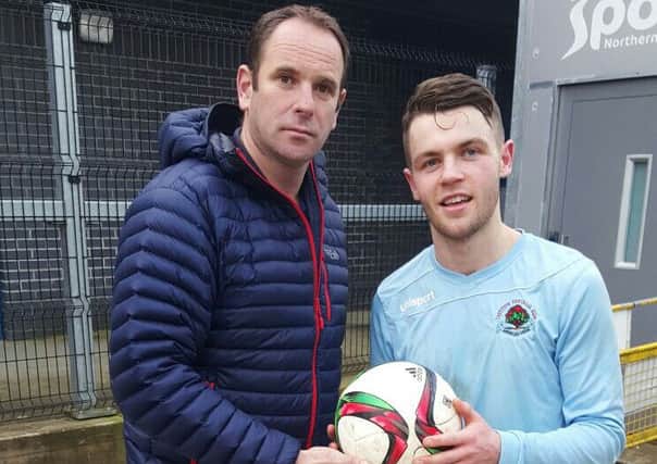 Andrew Russell, Institute Vice-Chairman presents Shane McGinty with the match ball following his hat-trick against Knockbreda.