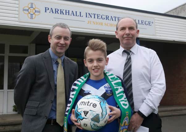 Parkhall Integrated College student Ross McCausland with school principal George Beattie and former Rangers and Northern Ireland player Paul McKnight during his visit to the school last week. INBT 09-373CS