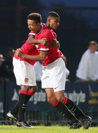 Manchester United's Marcus Rashford and Cameron Bothwick-Jackson celebrate at the 2014 Milk Cup at the Ballymena Showgrounds.