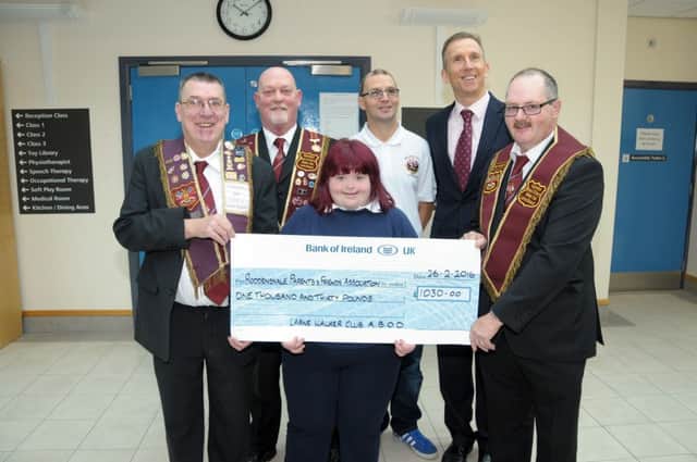 John Blair, Peter Ferguson, Jim McCombe and Jimmy Davey from the Walker Club of The Apprentice Boy's of Derry in Larne present Roddensvale Principal, Mr Madden and pupil Lori with a Â£1,030 cheque, the Club have made Roddensvale their appointed Charity. INLT 09-226-AM