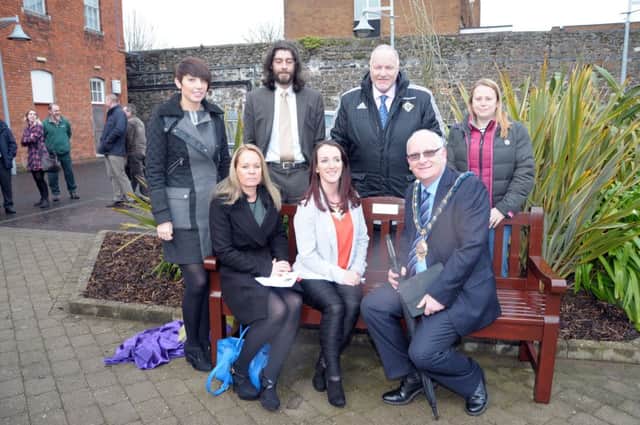 The Mayor of Mid and East Antrim Council, Councillor Billy Ashe and David Hilditch MLA with friends and colleagues of the late Lynda Waring on the bench that was unveiled in her memory. INCT 09-206-AM