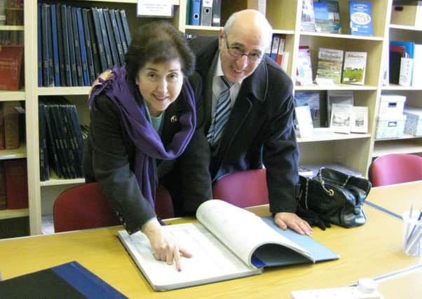 Stuart and Beverly Rosenblatt checking out the records at the North of Ireland Family History Society Research Centre and Library. INNT 09-520CON