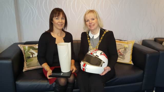 Tonia McNally, wife of the late Owen McNally, pictured with the Mayor of the Causeway Coast and Glens Borough Council, Cllr Michelle Knight-McQuillan, during a reception at the Mayor's Parlour after Owen was inducted into the RPS Group Hall of Fame award at the Motorcycle Awards. Also in the picture is one of Owen's helmets, which is part of the McCook collection left to Ballymoney Museum by the late Bert McCook.