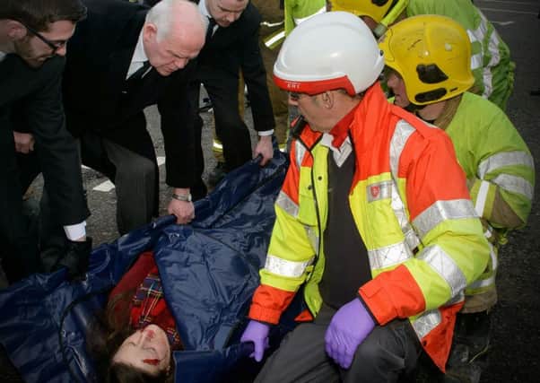 Pictured during the Road Traffic Collision reconstruction are staff from Mullan Funeral Directors, NI Fire and Rescue personnel, Barry and Yvonne Donnelly, Order of Malta, Coalisland and the young victim played by a volunteer actress.