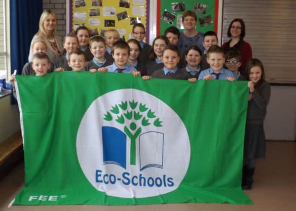 Churchtown PS, outside Cookstown, has been awarded a prestigious ECO Schools Green Flag by the environmental charity Keep Northern Ireland Beautiful.  Pictured are Mrs Callaghan, Mrs Johnston, Cathy Gorman and some children from Churchtown PS receiving their Green Flag.