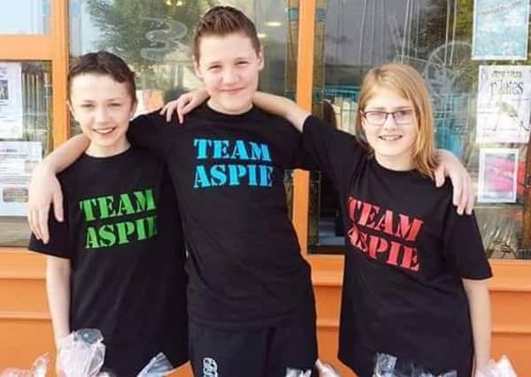 Three original members, Jane, Ben and Richard, centre, of Team Aspie