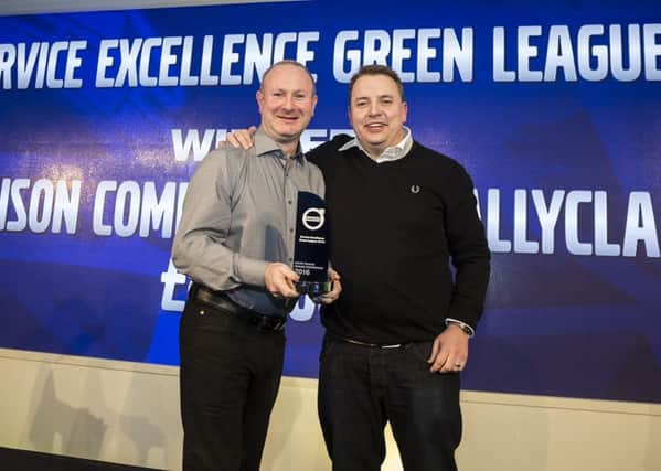 John Jenkins (left), Managing Director of Dennison Commercials, accepts the award for 'Service Excellence' from Tony Davis, Aftermarket & Customer Support Director, Volvo Group UK. INNT 10-505CON
