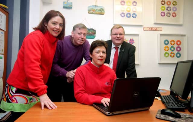 Checking out the online application process for Lisburn & Castlereagh City Council Councils Community Festivals Fund are Gay Sherry-Bingham, Centre Manager and Mandy Gilmore, Finance Administrator from Atalas Womens Centre.  While look on (l-r) are Alderman Paul Porter, Chairman of Lisburn & Castlereagh City Councils Leisure & Community Development Committee and Jonathan Craig MLA.