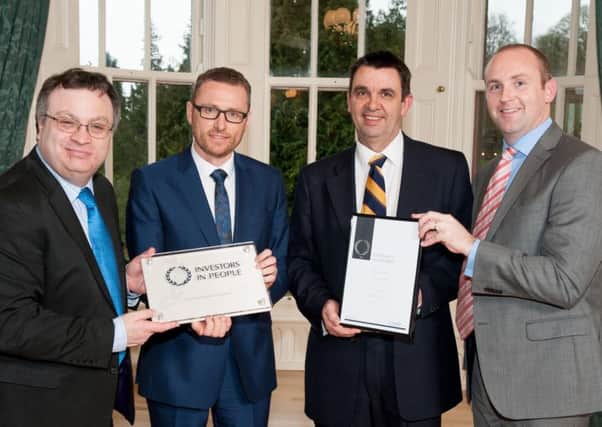 Pictured with Minister for Employment and Learning Stephen Farry and Northern Ireland Commissioner (UK Commission for Employment and Skills (UKCES)) Mark Huddleston, are Derek Wright and Ian McConaghy, principal of Dromore High School, receiving the school's Investors in People accreditation.
